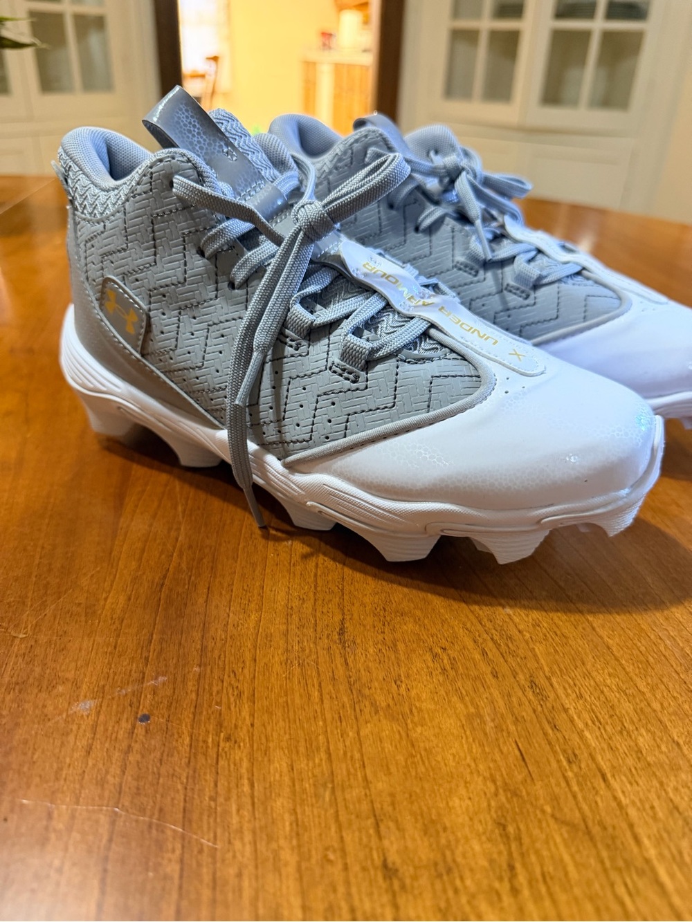 Under Armour Kids Gray and White Cleats with Traction Sole